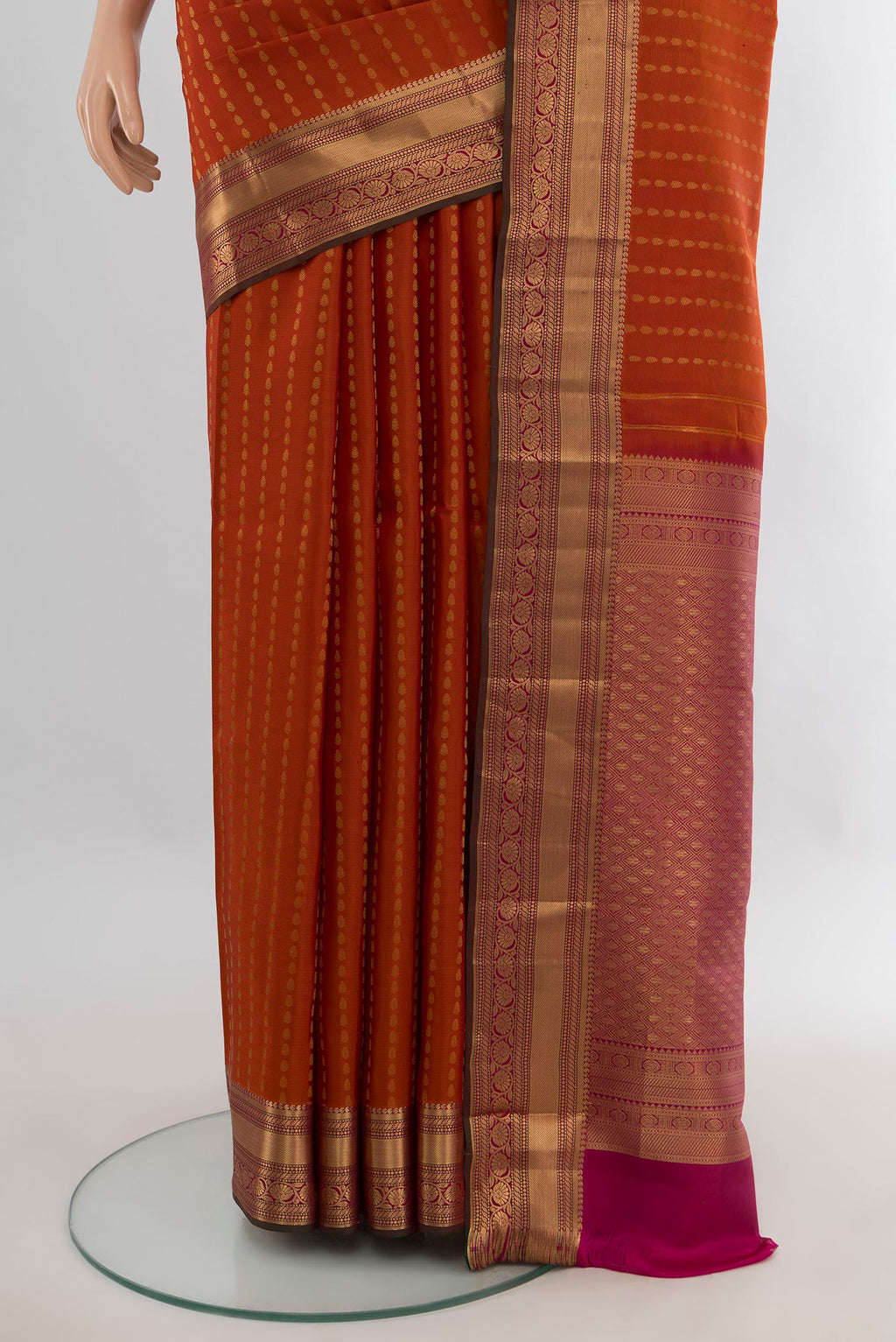 Pleats and pallu of Pure Silk Rust Kanchipuram Saree with Zari Butta on the body and Zari Border. 