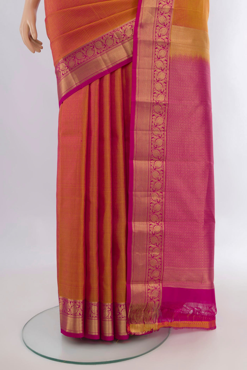 Pleats and pallu of Pure Silk Mustard Dual Tone Kanchipuram Saree with Zari Butta on the body and Zari Border. 