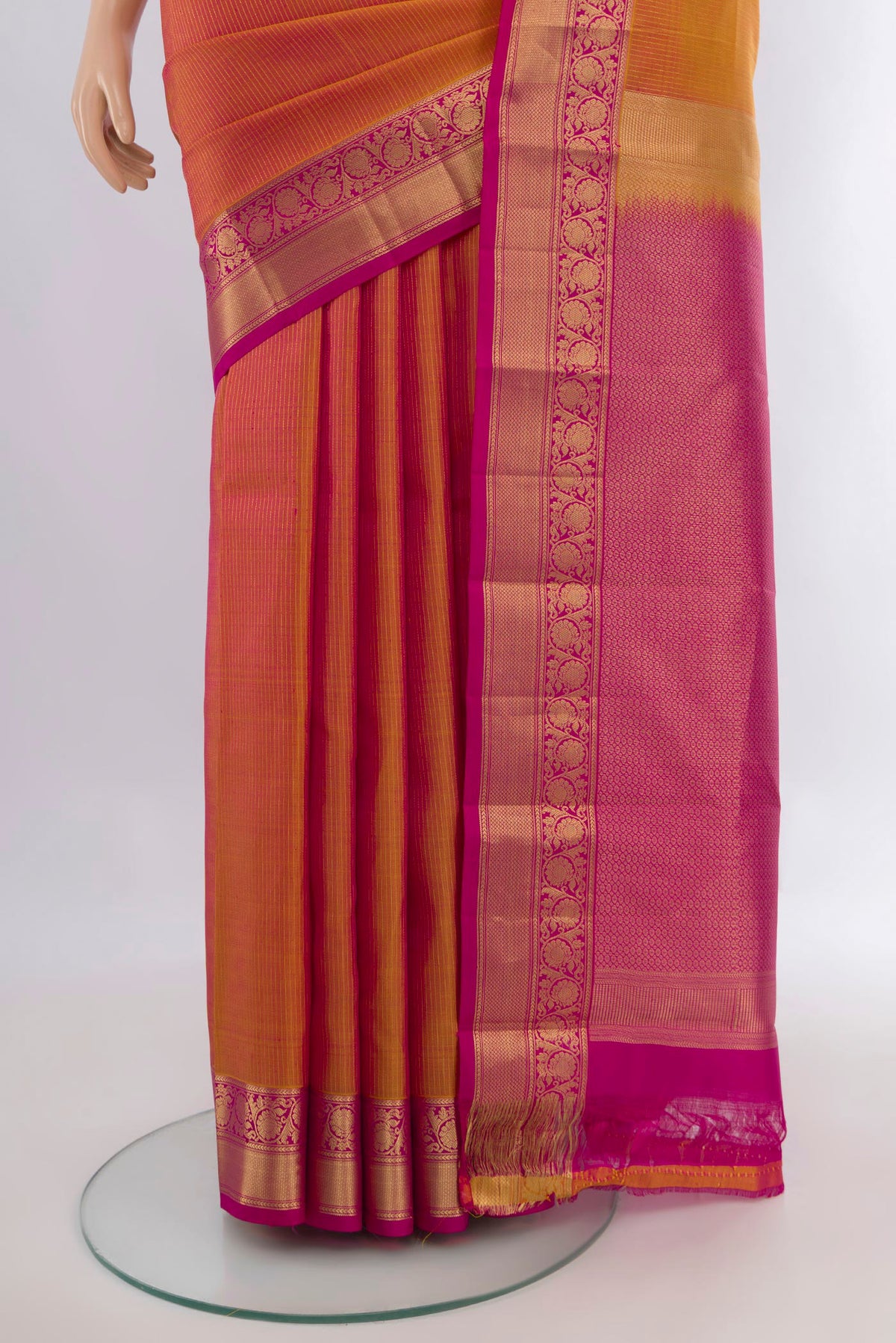 Pleats and pallu of Pure Silk Mustard Dual Tone Kanchipuram Saree with Zari Butta on the body and Zari Border. 