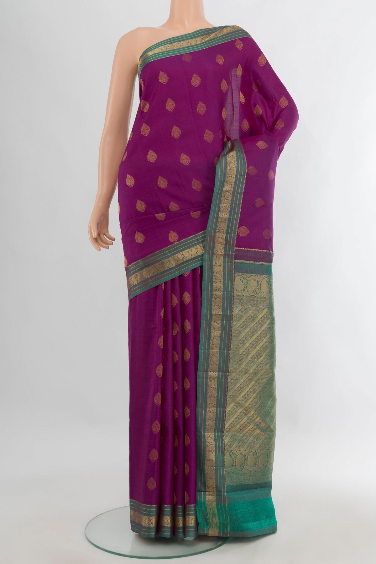 Pure Silk Magenta Kanchipuram Saree with Zari Butta on the body and Zari Border.  displayed on a mannequin