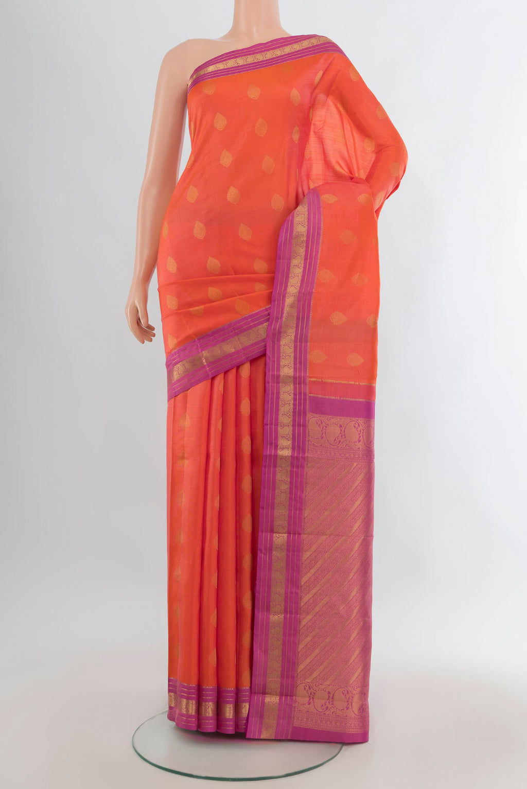 Pure Silk Orange Kanchipuram Saree with Zari Butta on the body and Zari Border.  displayed on a mannequin