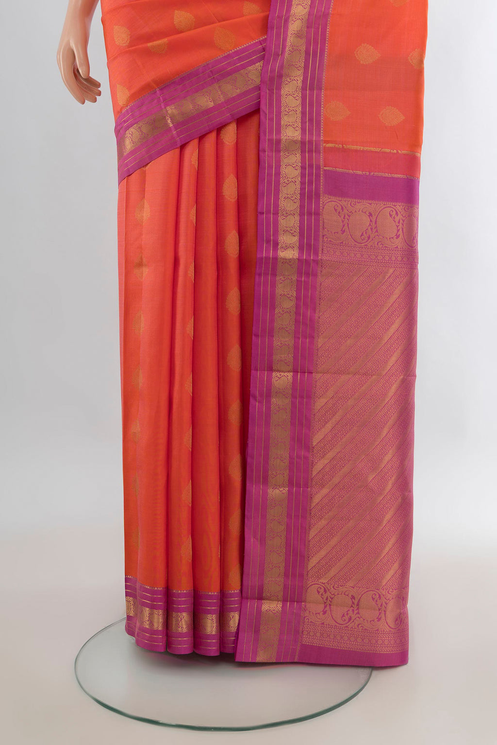Pleats and pallu of Pure Silk Orange Kanchipuram Saree with Zari Butta on the body and Zari Border. 