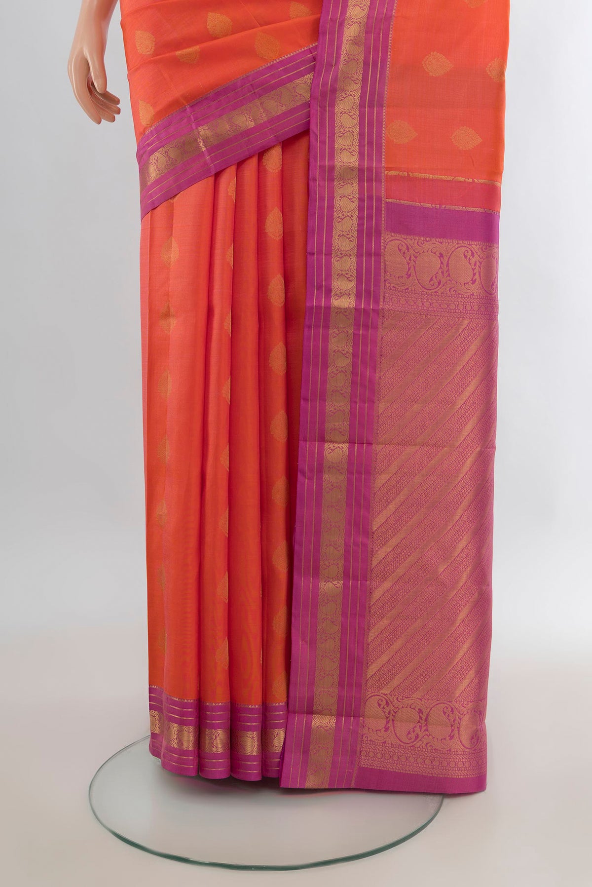 Pleats and pallu of Pure Silk Orange Kanchipuram Saree with Zari Butta on the body and Zari Border. 