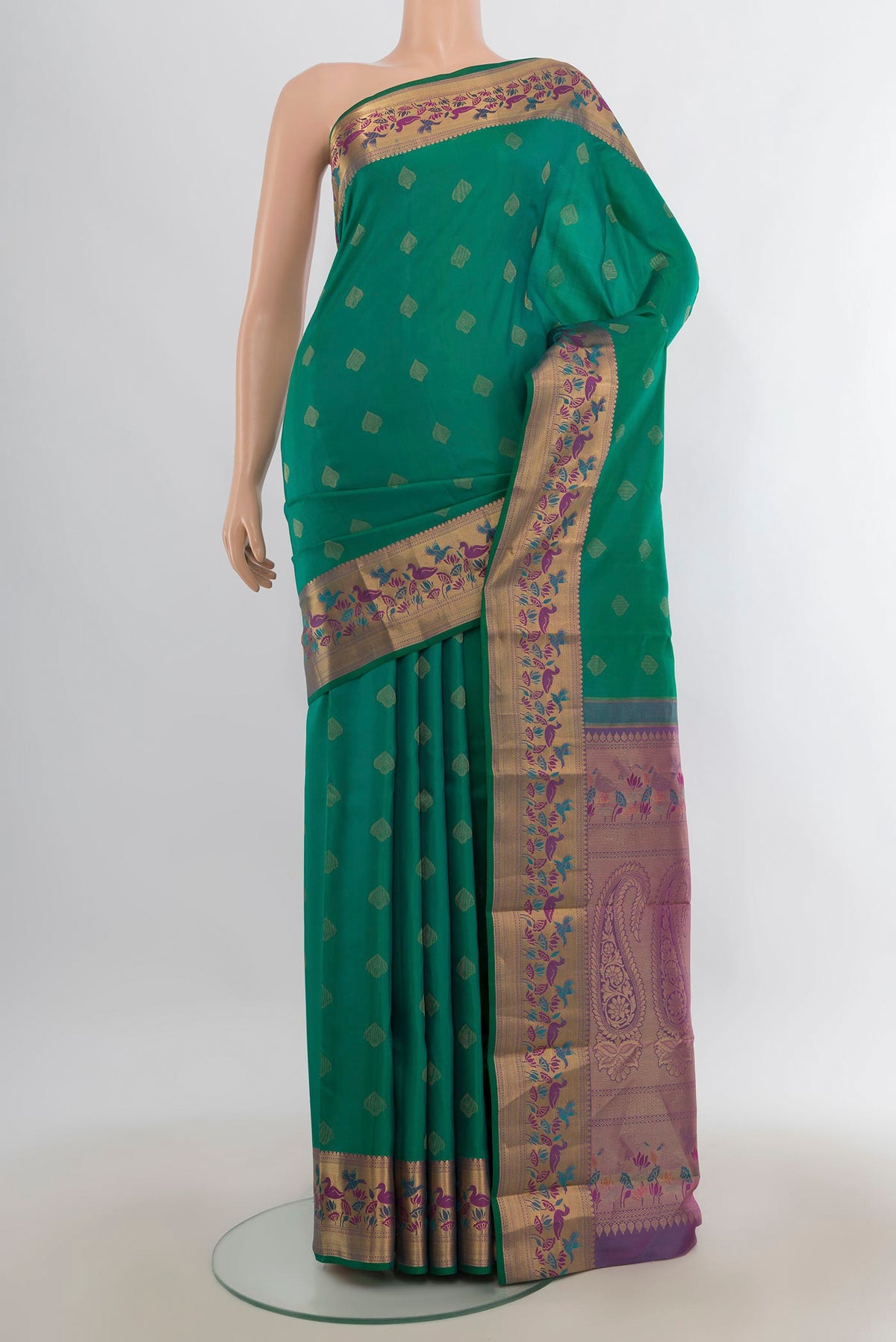 Pure Silk Green Kanjivaram Saree with Zari Butta on the body and Zari Border.  displayed on a mannequin