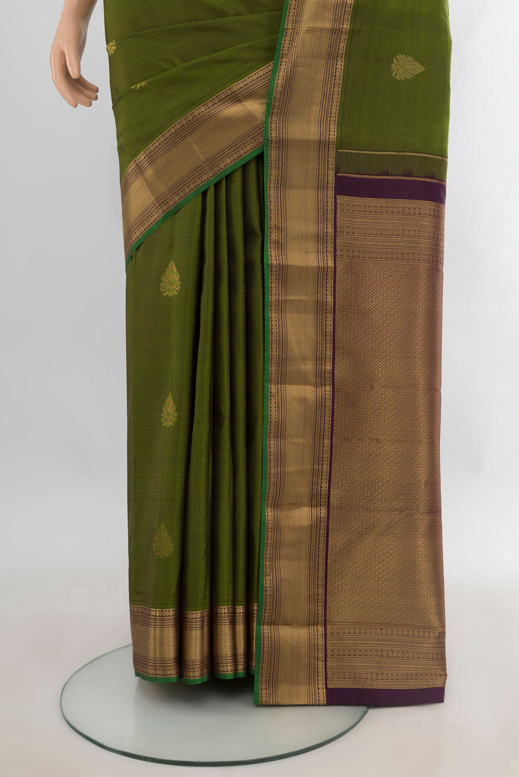 Pleats and pallu of Pure Silk Mehandi Green Kanchipuram Saree with Zari Butta on the body and Zari Border. 