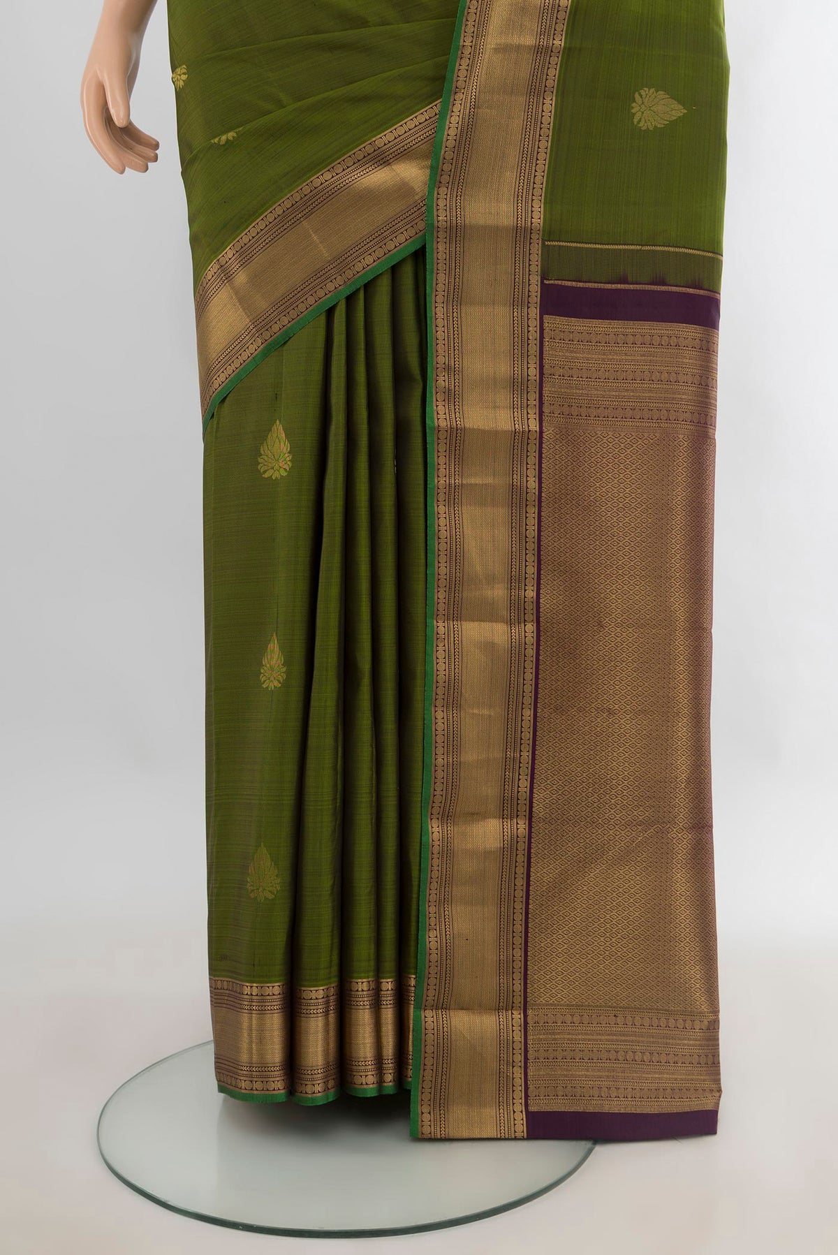 Pleats and pallu of Pure Silk Mehandi Green Kanchipuram Saree with Zari Butta on the body and Zari Border. 