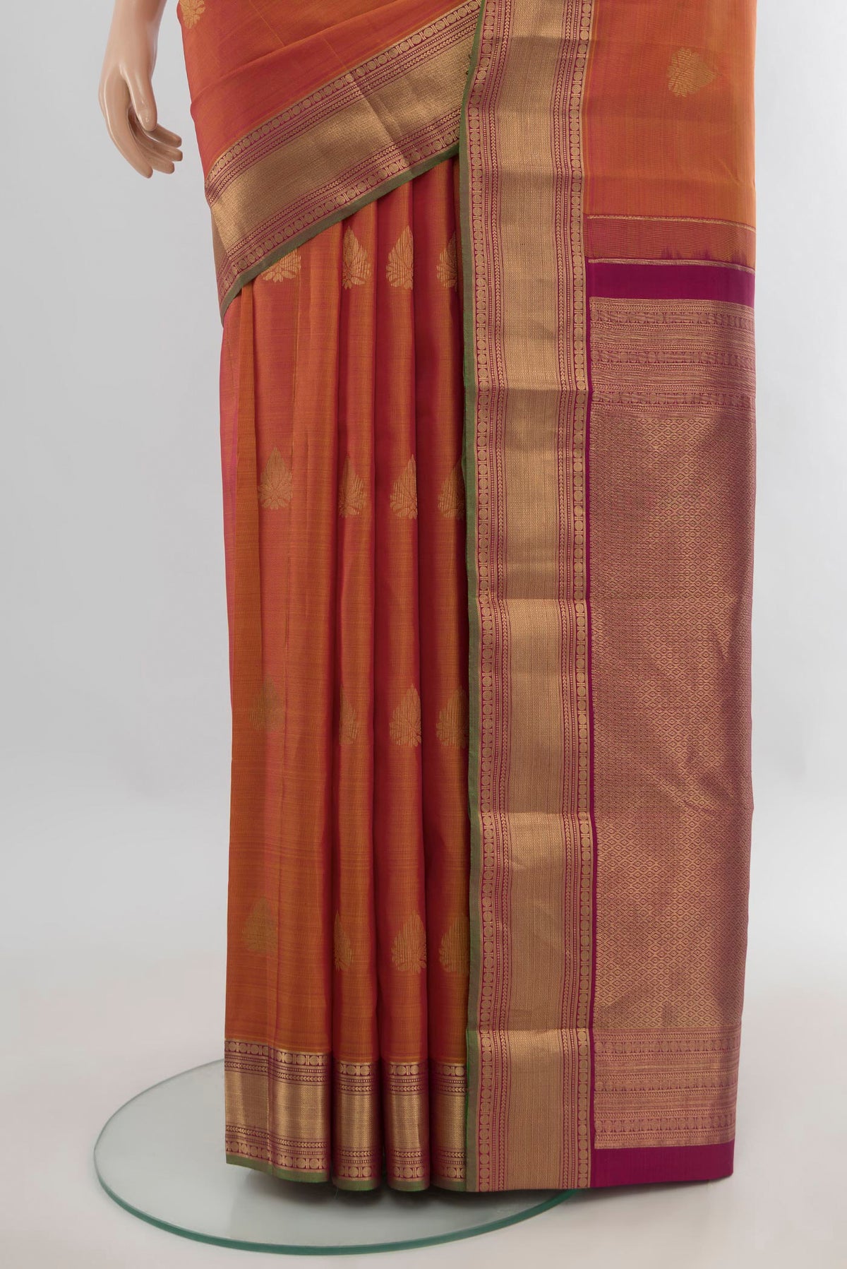 Pleats and pallu of Pure Silk Rust Kanchipuram Saree with Zari Butta on the body and Zari Border. 