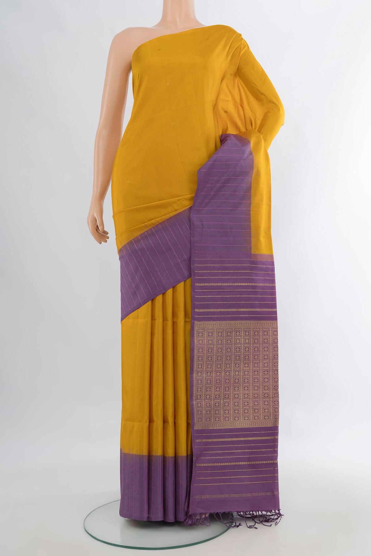 Pure Silk Mustard Soft Saree with Zari Butta on the body and One Side Border.  displayed on a mannequin