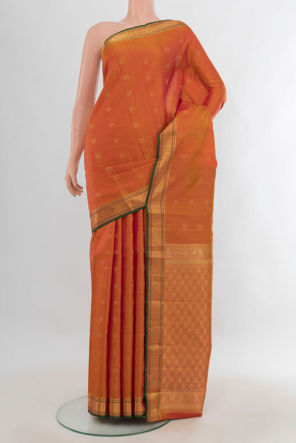 Pure Silk Orange Kanchipuram Saree with Zari Butta on the body and Zari Border.  displayed on a mannequin