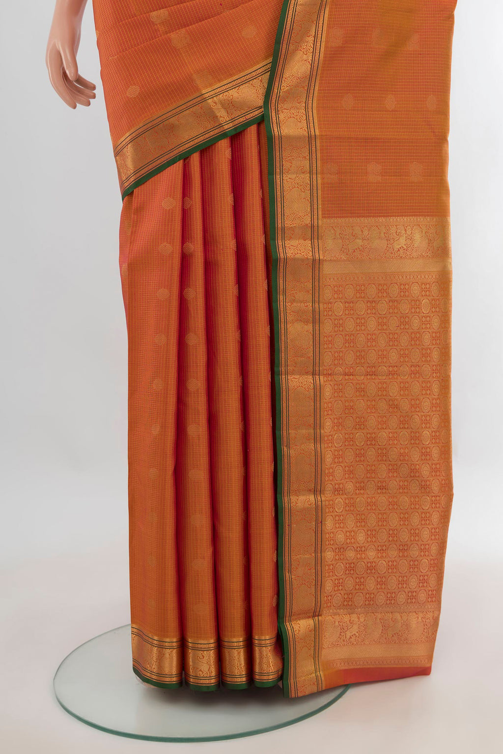 Pleats and pallu of Pure Silk Orange Kanchipuram Saree with Zari Butta on the body and Zari Border. 