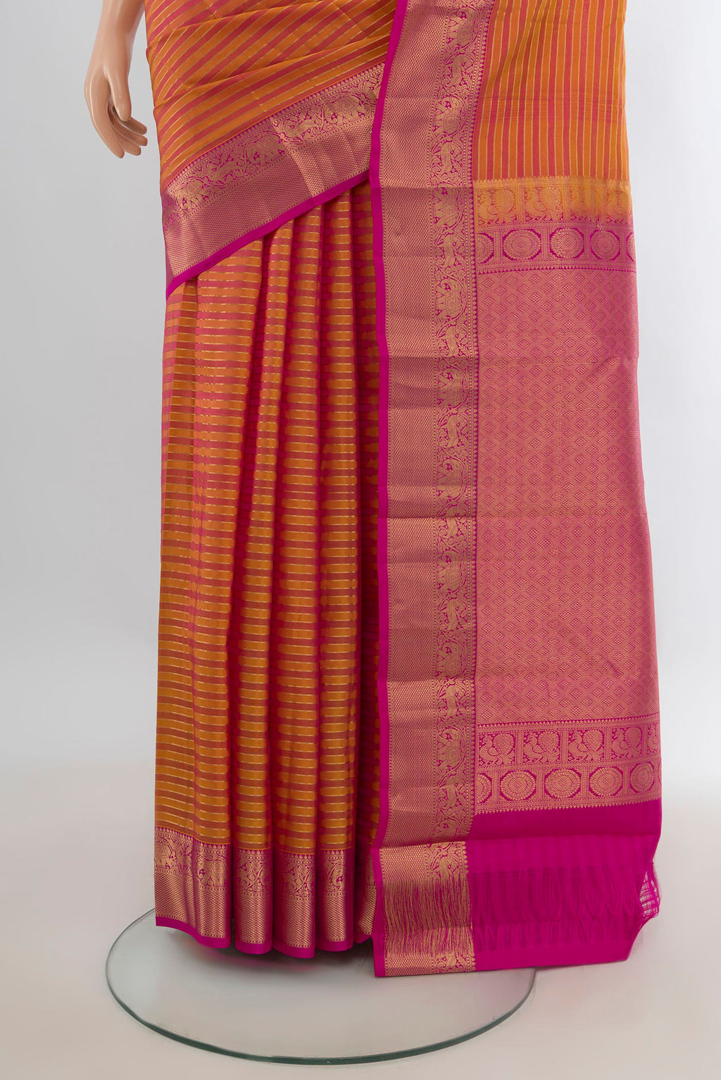 Pleats and pallu of Pure Silk Mustard Kanjivaram Saree with Stripes on the body and Zari Border. 