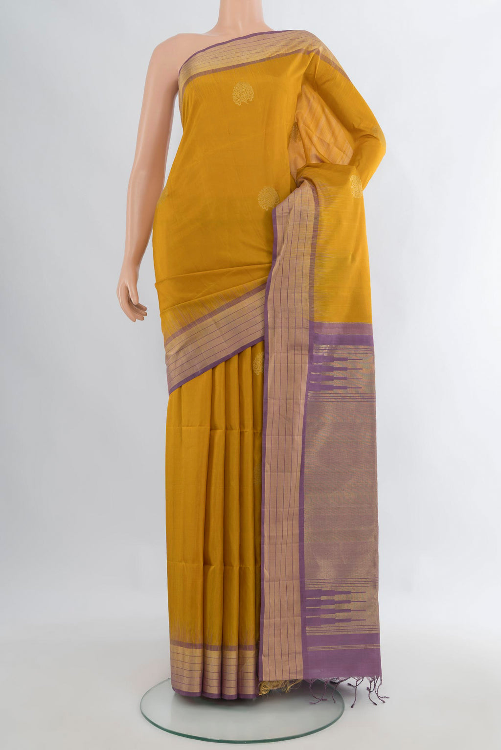 Pure Silk Mustard Soft Saree with Zari Butta on the body and Zari Border.  displayed on a mannequin