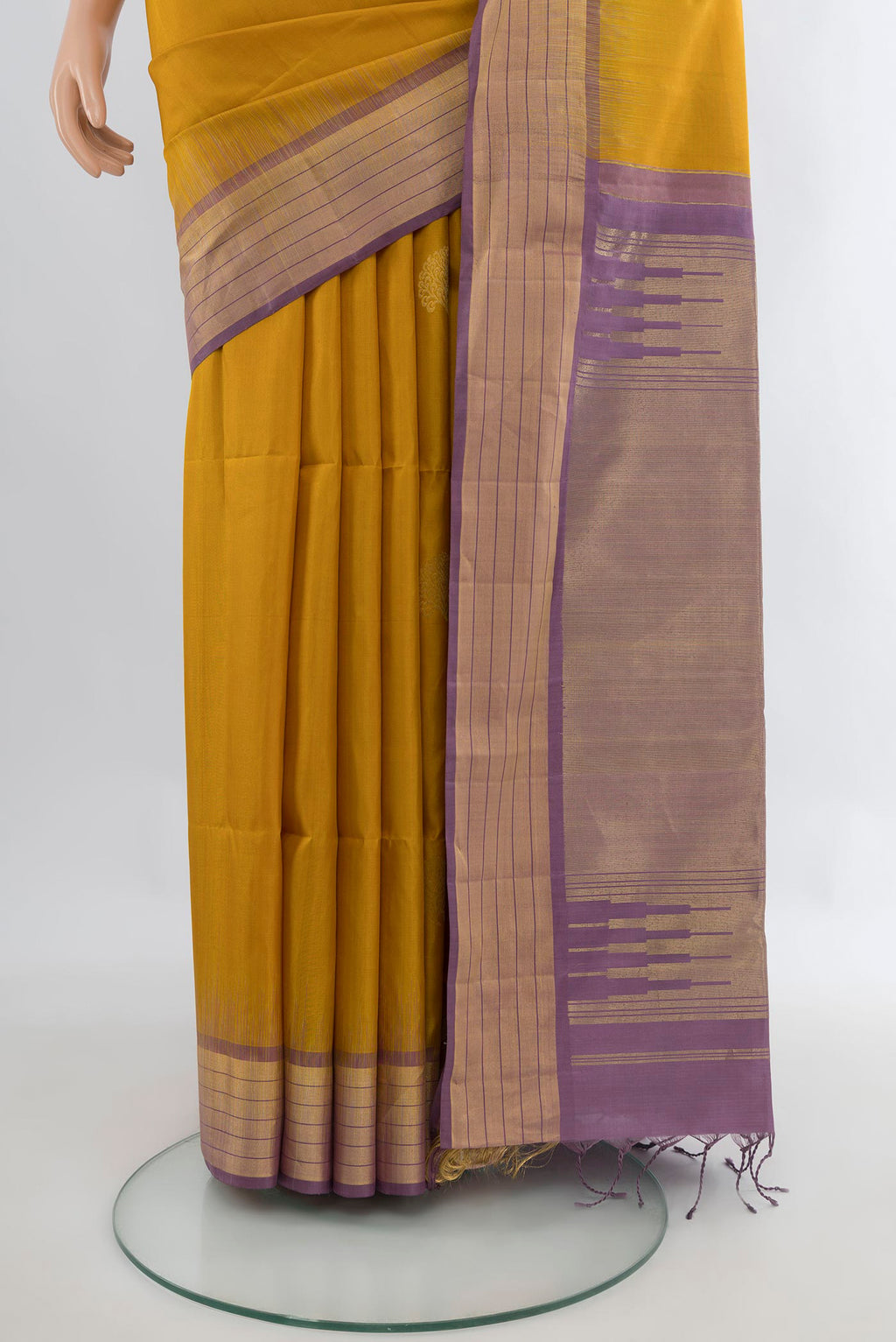 Pleats and pallu of Pure Silk Mustard Soft Saree with Zari Butta on the body and Zari Border. 