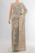 Pure Silk Beige Banarasi Raw Saree with Zari Butta on the body and Zari Border.  displayed on a mannequin