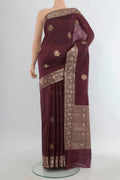 Pure Silk Coffee Brown Banarasi Raw Saree with Zari Butta on the body and Zari Border.  displayed on a mannequin