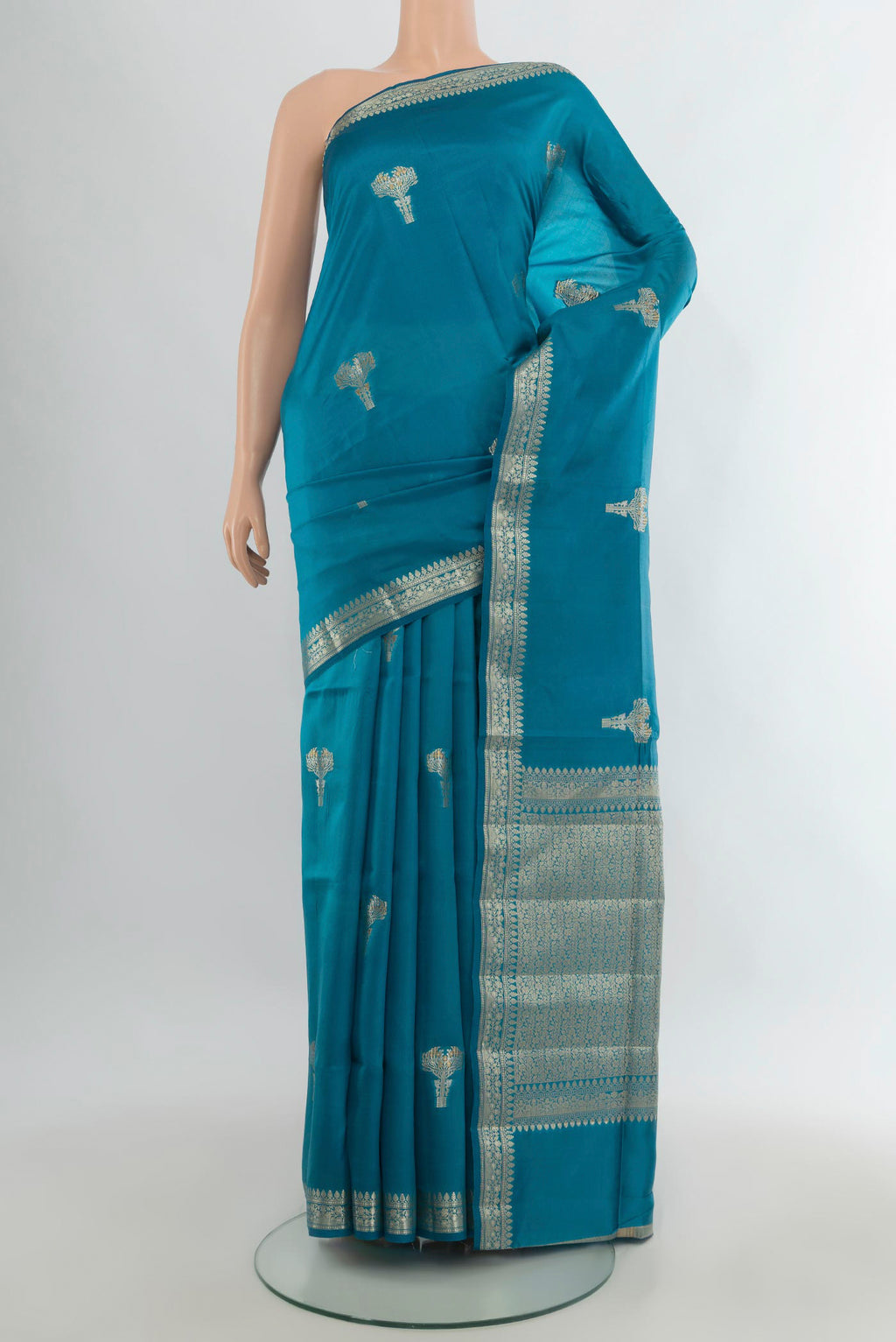 Pure Silk Light Blue Banarasi Raw Saree with Zari Butta on the body and Zari Border.  displayed on a mannequin