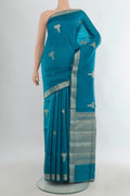 Pure Silk Light Blue Banarasi Raw Saree with Zari Butta on the body and Zari Border.  displayed on a mannequin