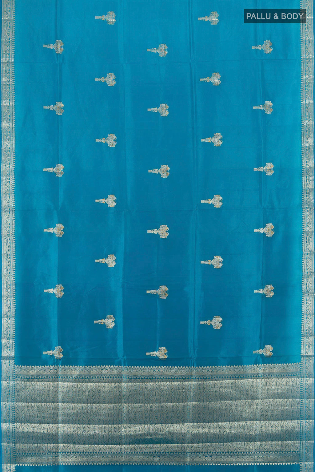 Flat view of Pure Silk Light Blue Banarasi Raw Saree with Zari Butta on the body and Zari Border. 