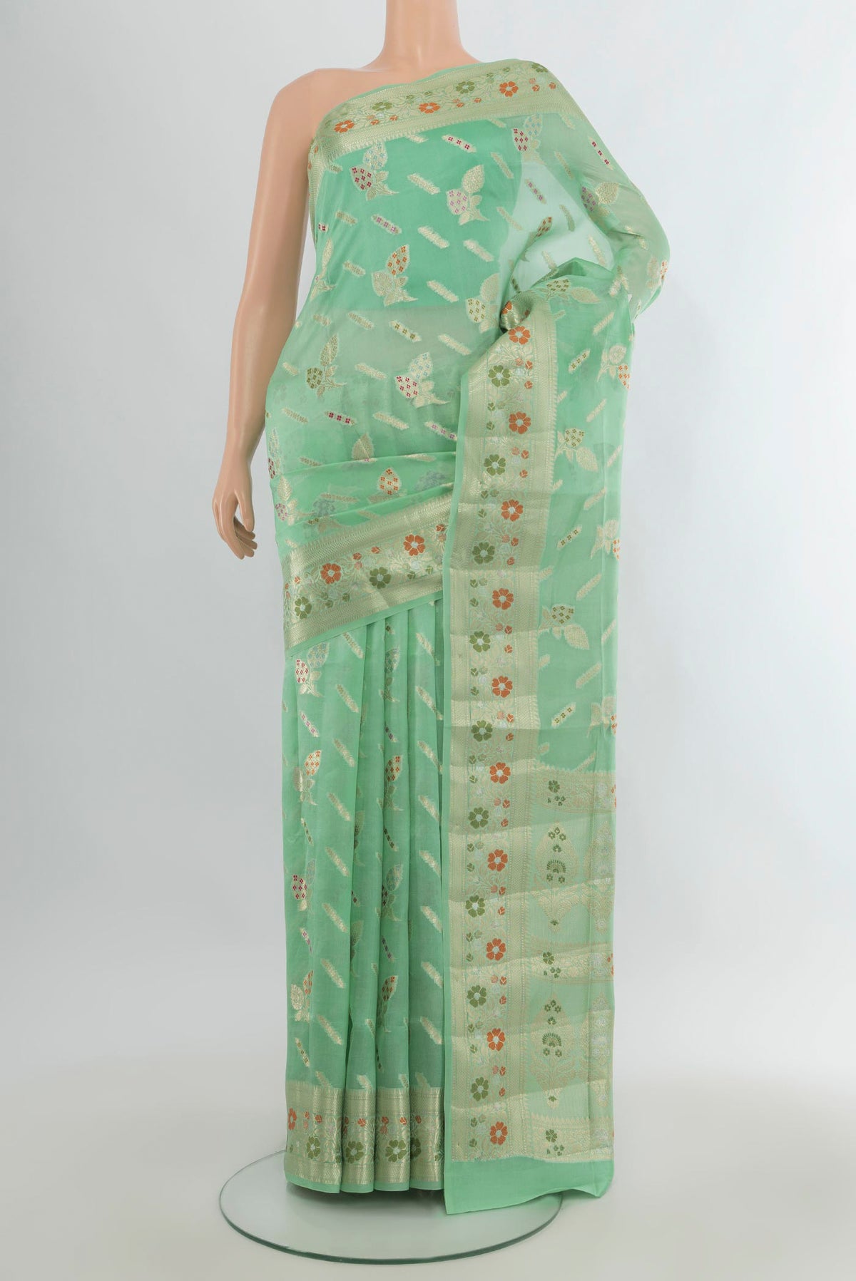 Pure Silk Light Green Banarasi Raw Saree with Zari Butta on the body and Zari Border.  displayed on a mannequin