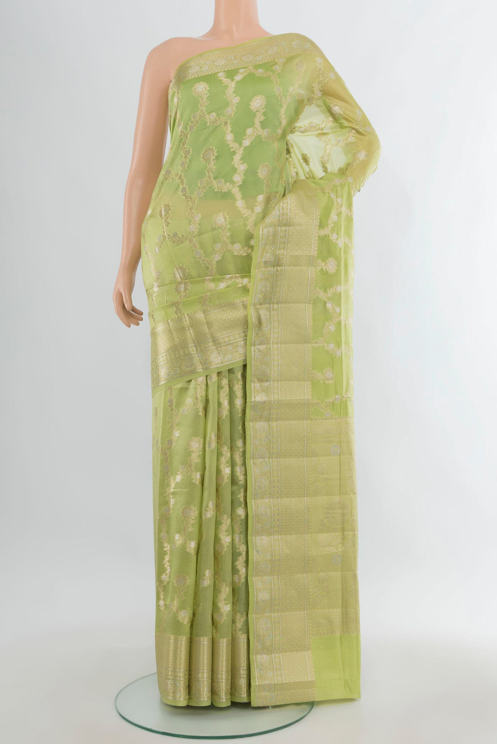 Pure Silk Pista Green Banarasi Raw Saree with Zari Butta on the body and Zari Border.  displayed on a mannequin