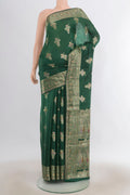Pure Silk Green Banarasi Tussar Saree with Zari Butta on the body and Zari Border.  displayed on a mannequin