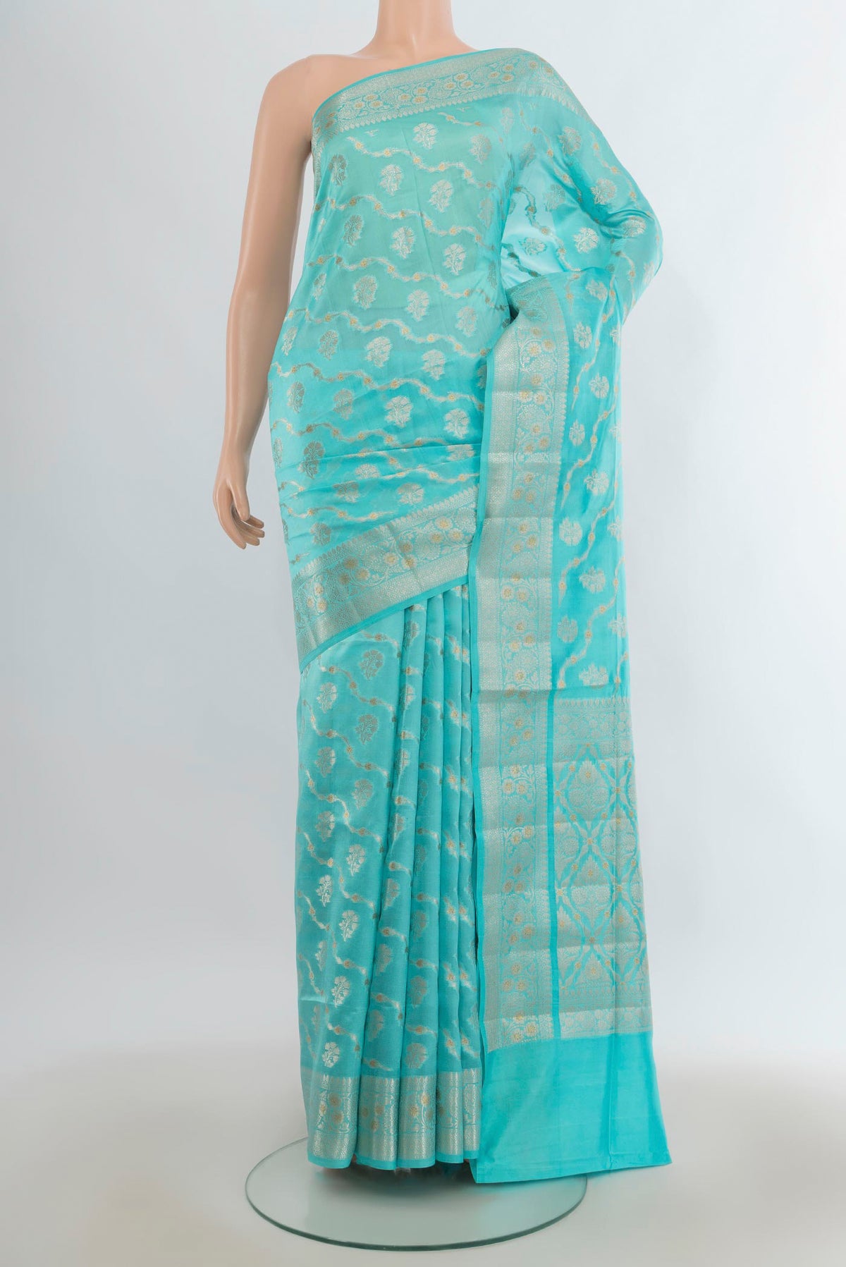 Pure Silk Sky Blue Banarasi Raw Saree with Zari Butta on the body and Zari Border.  displayed on a mannequin