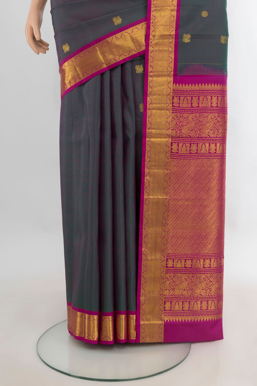 Pleats and pallu of Pure Silk Green with Pink Color Kanjivaram Saree with Zari Butta on the body and Zari Border. 