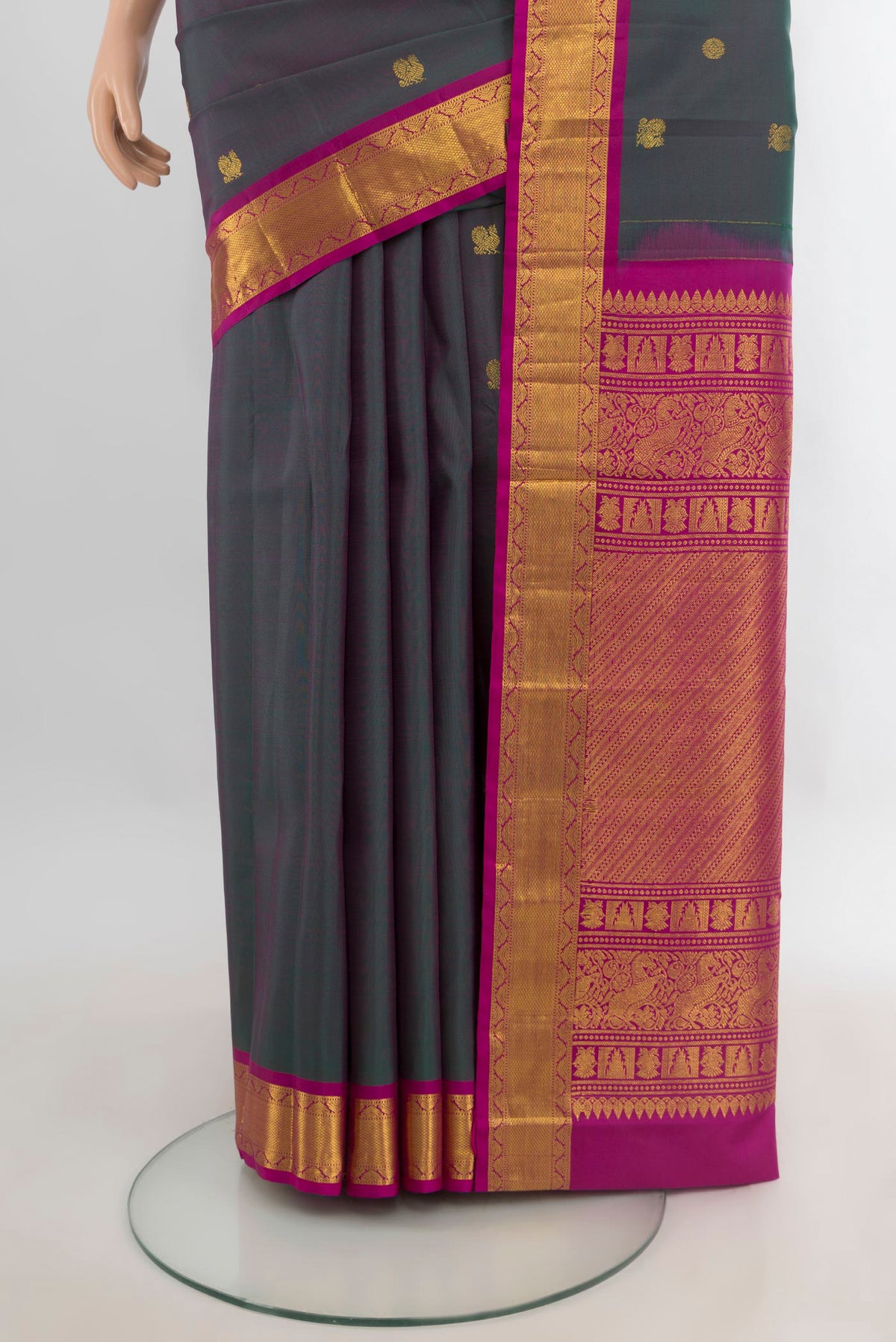 Pleats and pallu of Pure Silk Green with Pink Color Kanjivaram Saree with Zari Butta on the body and Zari Border. 