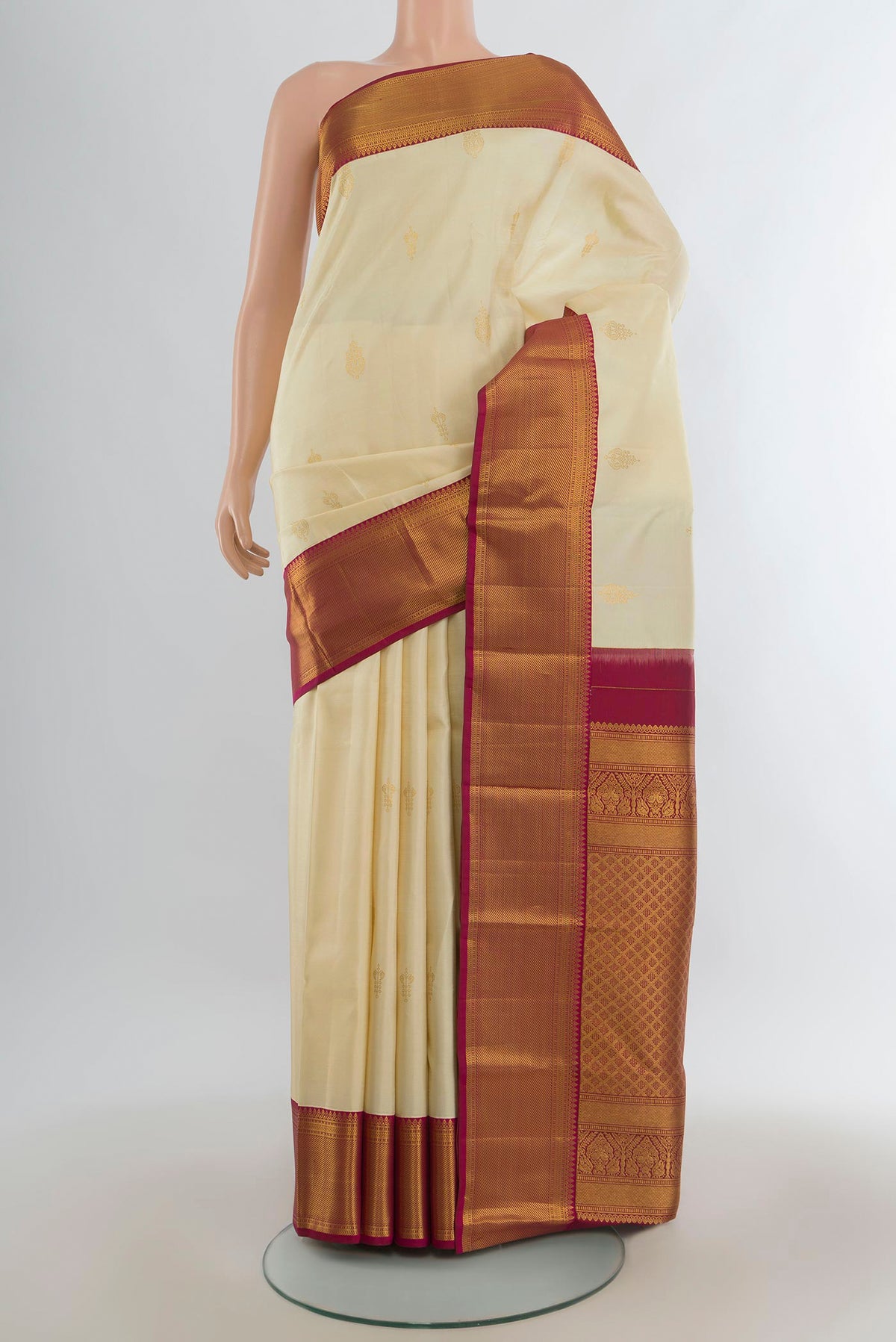 Pure Silk Cream Kanjivaram Saree with Zari Butta on the body and Zari Border.  displayed on a mannequin