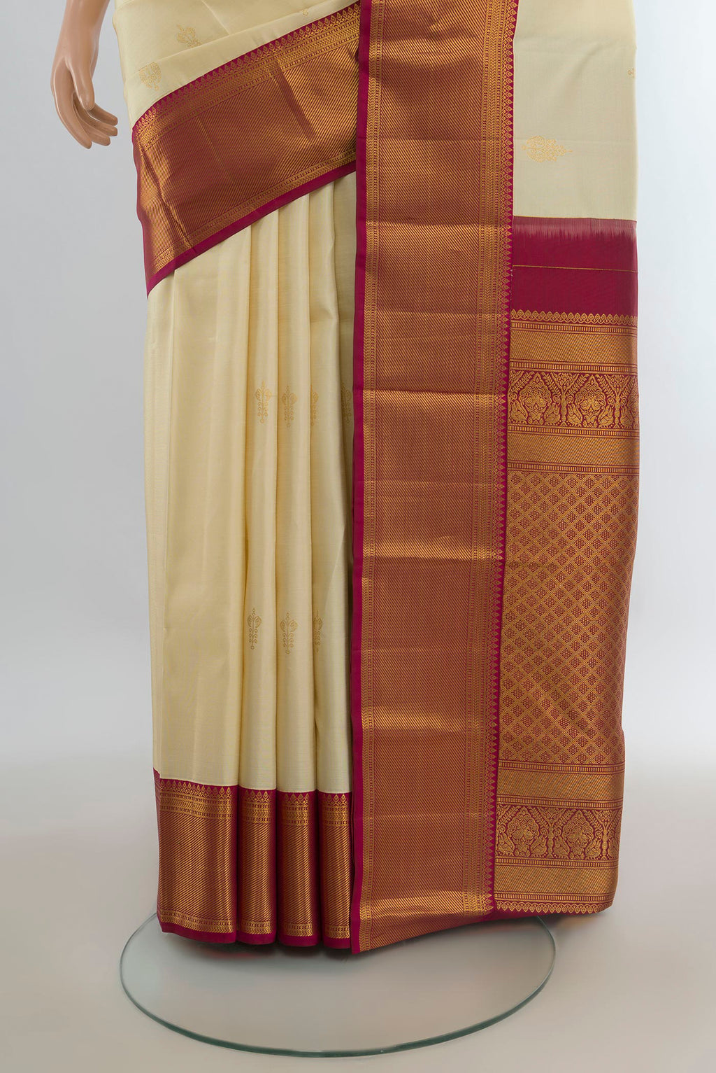 Pleats and pallu of Pure Silk Cream Kanjivaram Saree with Zari Butta on the body and Zari Border. 