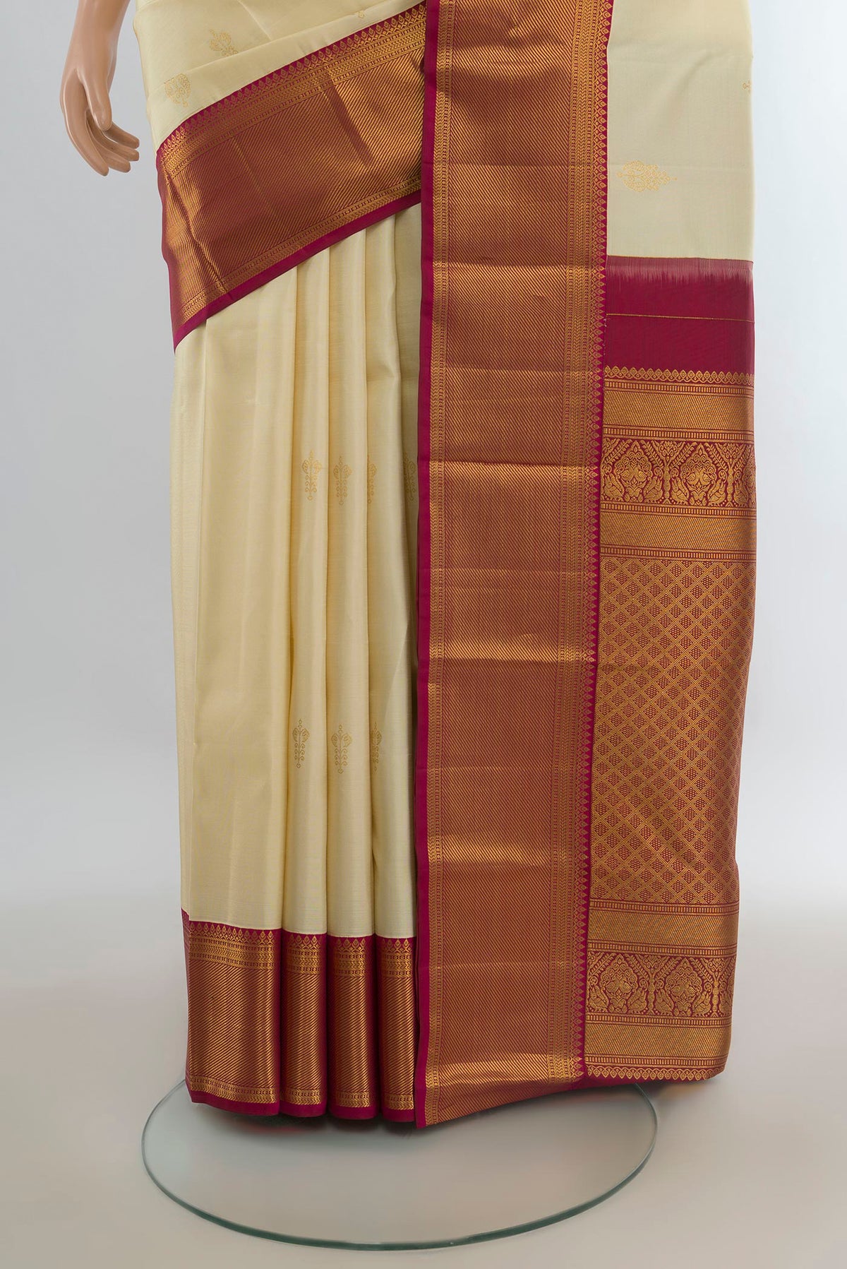 Pleats and pallu of Pure Silk Cream Kanjivaram Saree with Zari Butta on the body and Zari Border. 