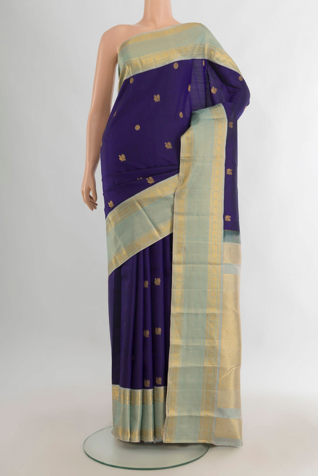 Pure Silk Navy Blue Kanjivaram Saree with Zari Butta on the body and Zari Border.  displayed on a mannequin
