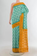 Pure Silk Green Pochampally Saree with Ikat design on the body and Zari Border.  displayed on a mannequin