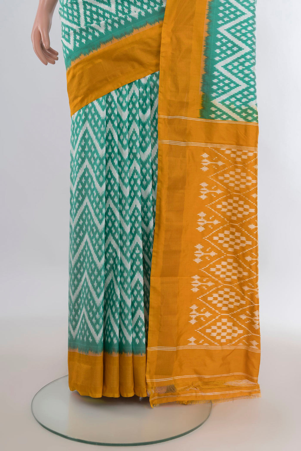 Pleats and pallu of Pure Silk Green Pochampally Saree with Ikat design on the body and Zari Border. 