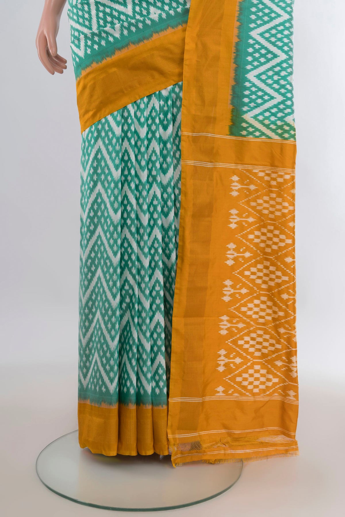 Pleats and pallu of Pure Silk Green Pochampally Saree with Ikat design on the body and Zari Border. 