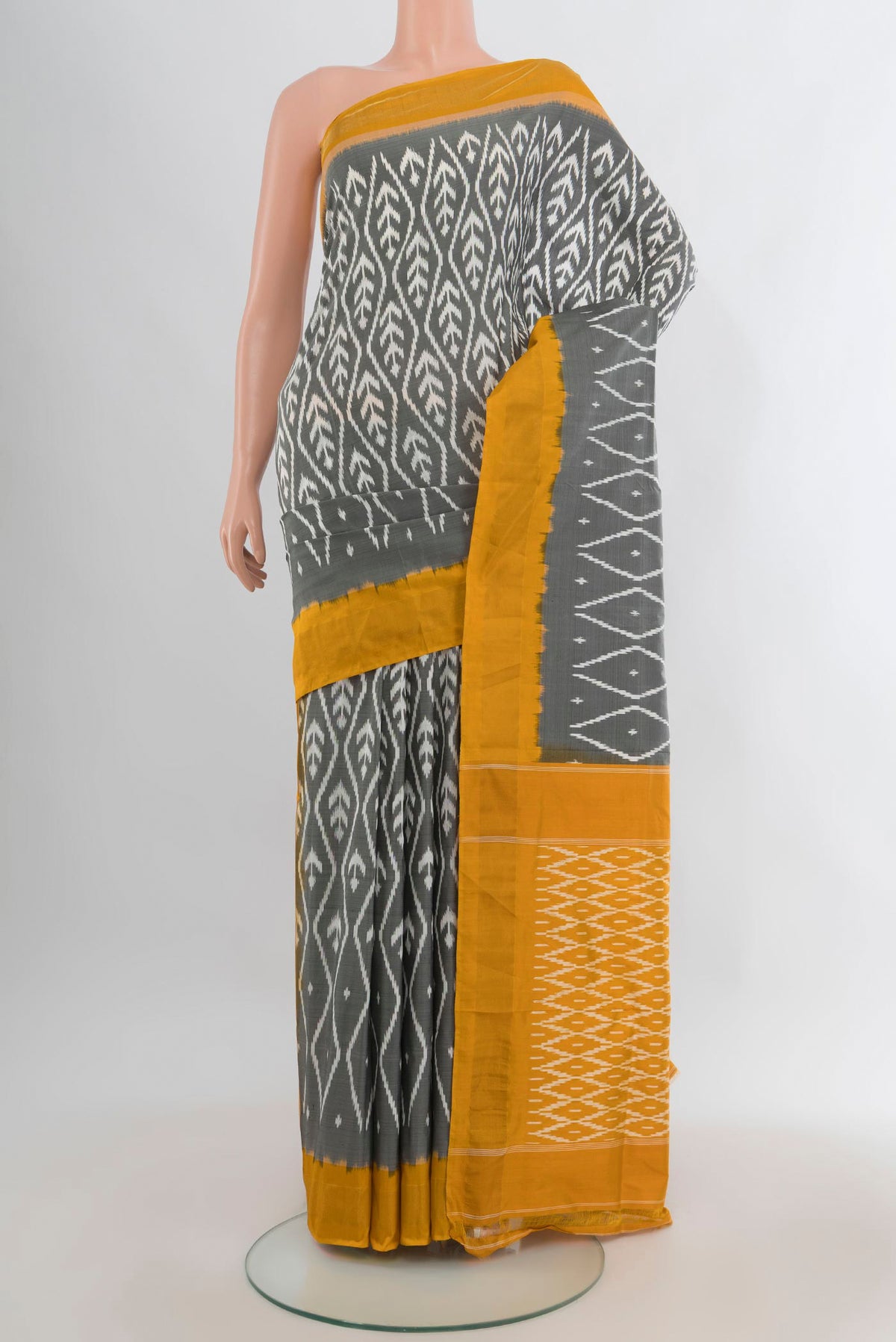 Pure Silk Grey Pochampally Saree with Ikat design on the body and Zari Border.  displayed on a mannequin