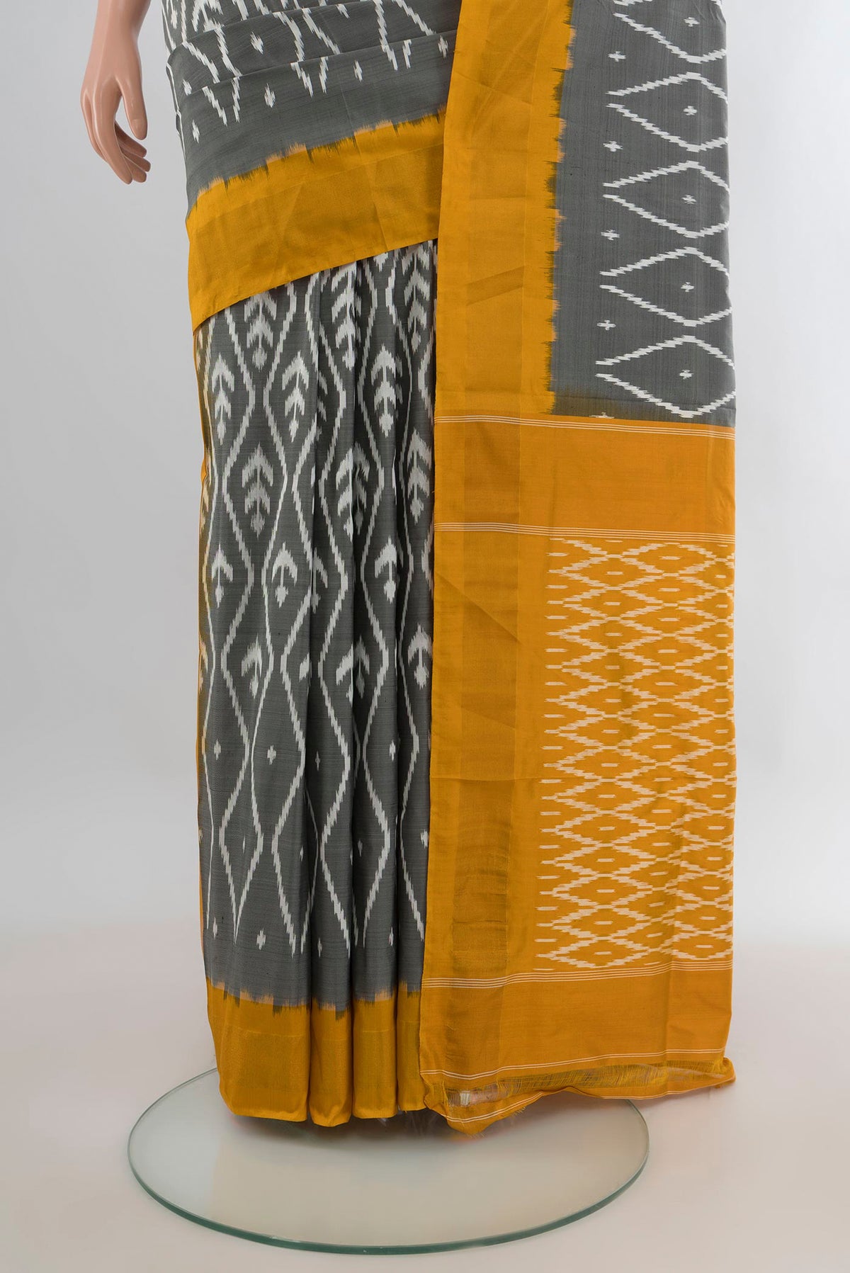 Pleats and pallu of Pure Silk Grey Pochampally Saree with Ikat design on the body and Zari Border. 