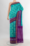 Pure Silk Turquoise Pochampally Saree with Ikat design on the body and Ikat Border.  displayed on a mannequin