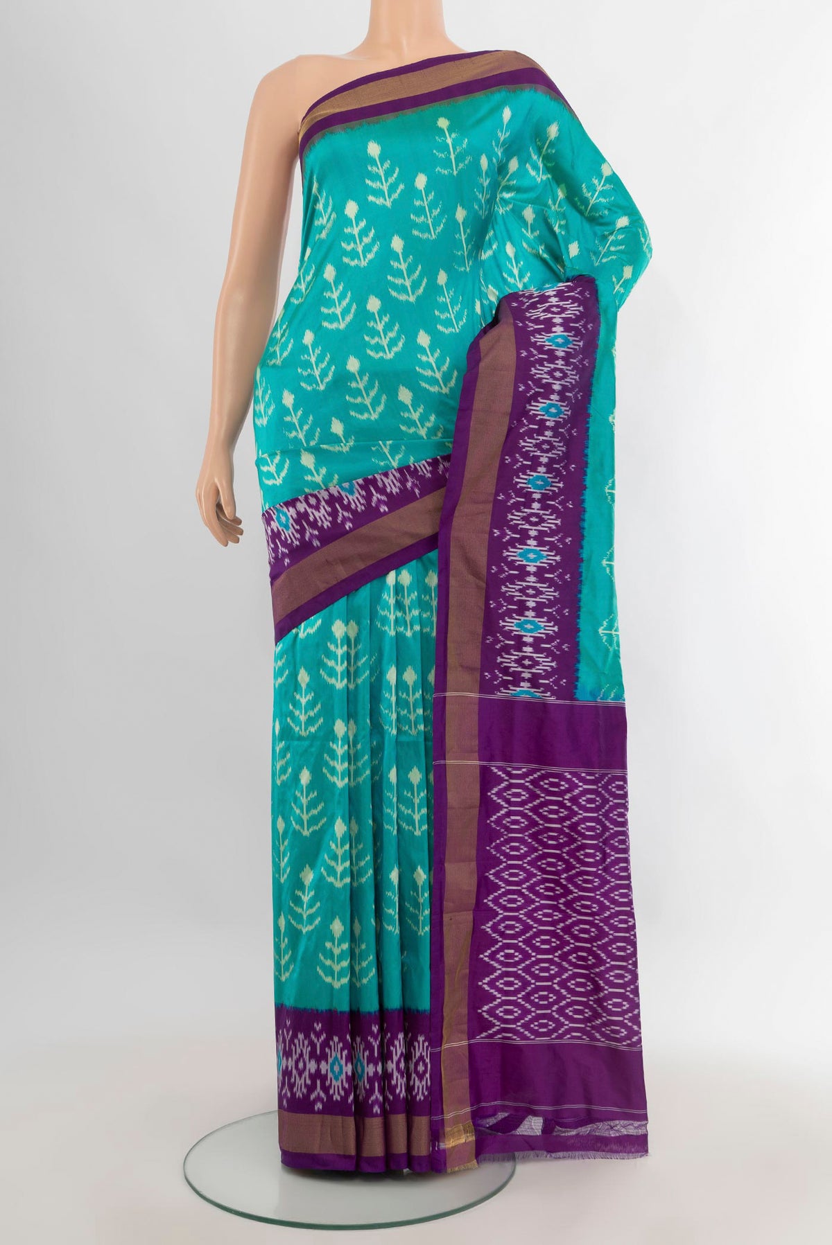Pure Silk Turquoise Pochampally Saree with Ikat design on the body and Ikat Border.  displayed on a mannequin