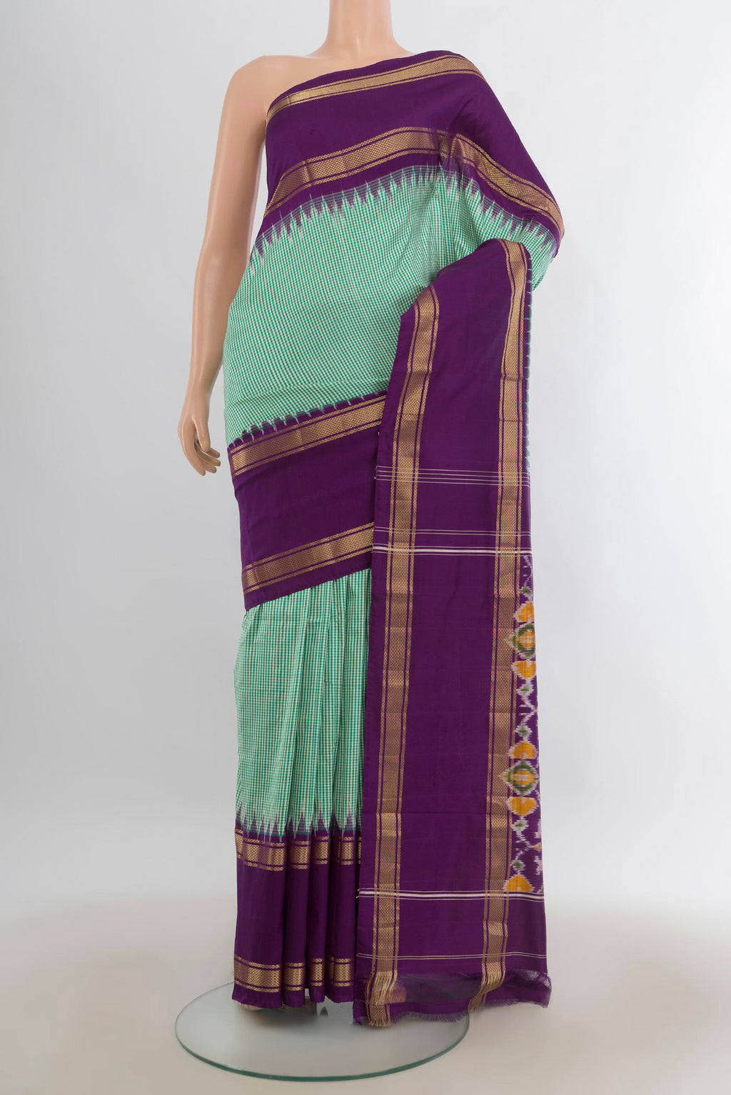 Pure Silk Mint Green Pochampally Saree with Checked design on the body and Zari Border.  displayed on a mannequin