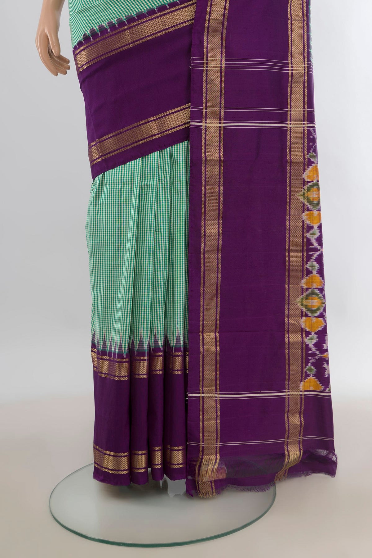 Pleats and pallu of Pure Silk Mint Green Pochampally Saree with Checked design on the body and Zari Border. 