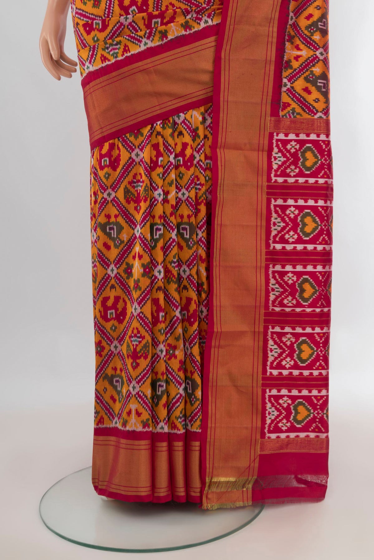 Pleats and pallu of Pure Silk Orange Pochampally Saree with Pure Ikat on the body and Zari Border. 