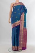 Pure Silk Peacock Blue Soft Saree with Zari Butta on the body and Zari Border.  displayed on a mannequin