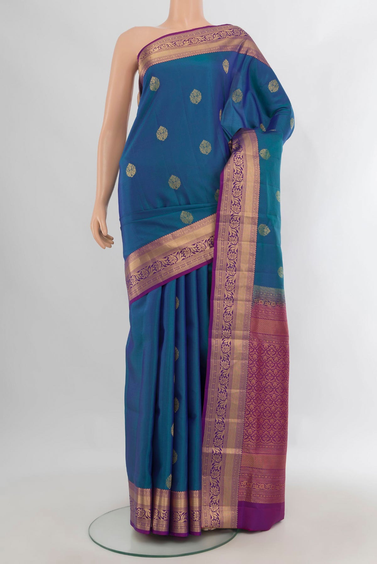 Pure Silk Peacock Blue Soft Saree with Zari Butta on the body and Zari Border.  displayed on a mannequin