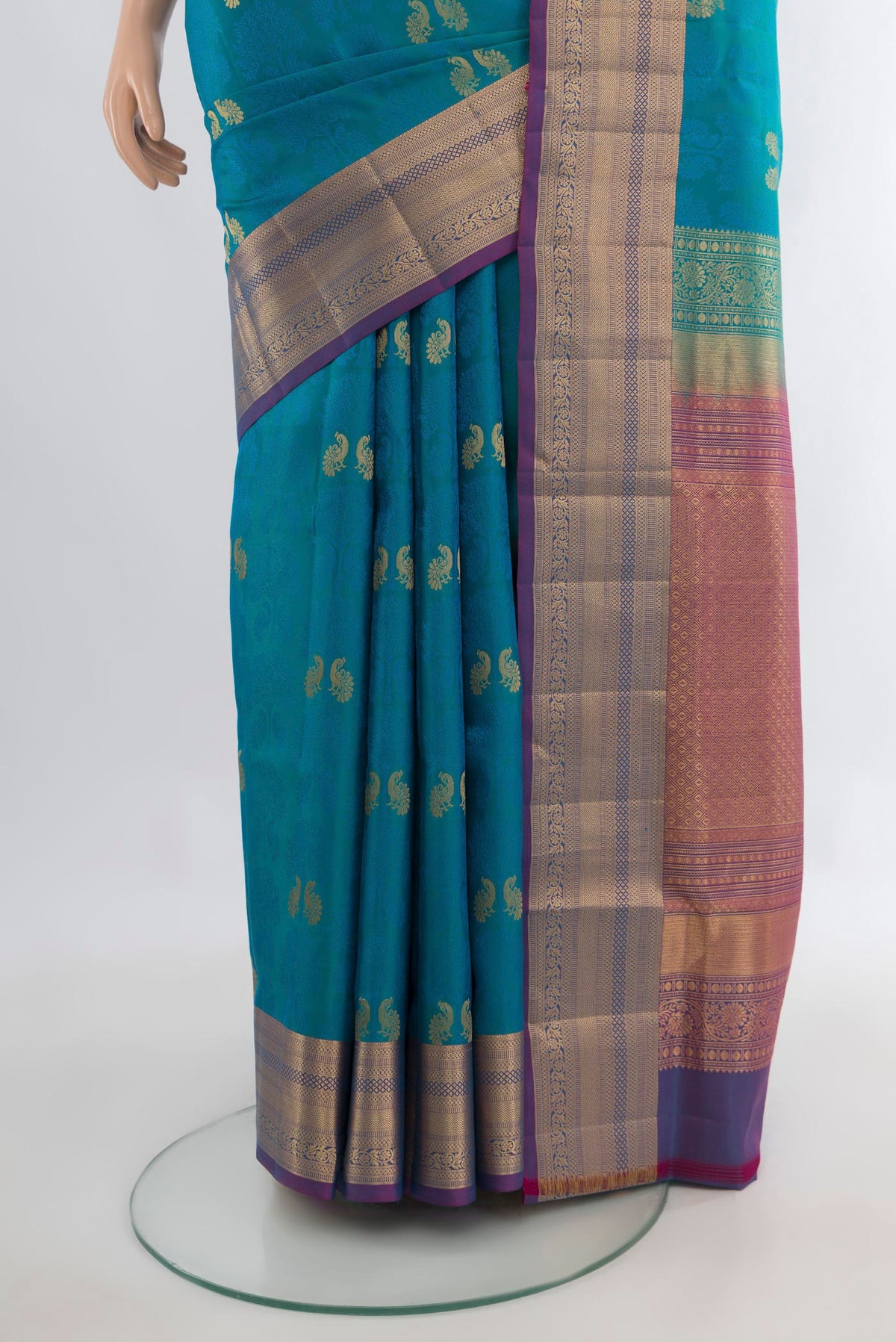 Pleats and pallu of Pure Silk Peacock Blue Soft Saree with Jacquard With Zari Butta on the body and Zari Border. 
