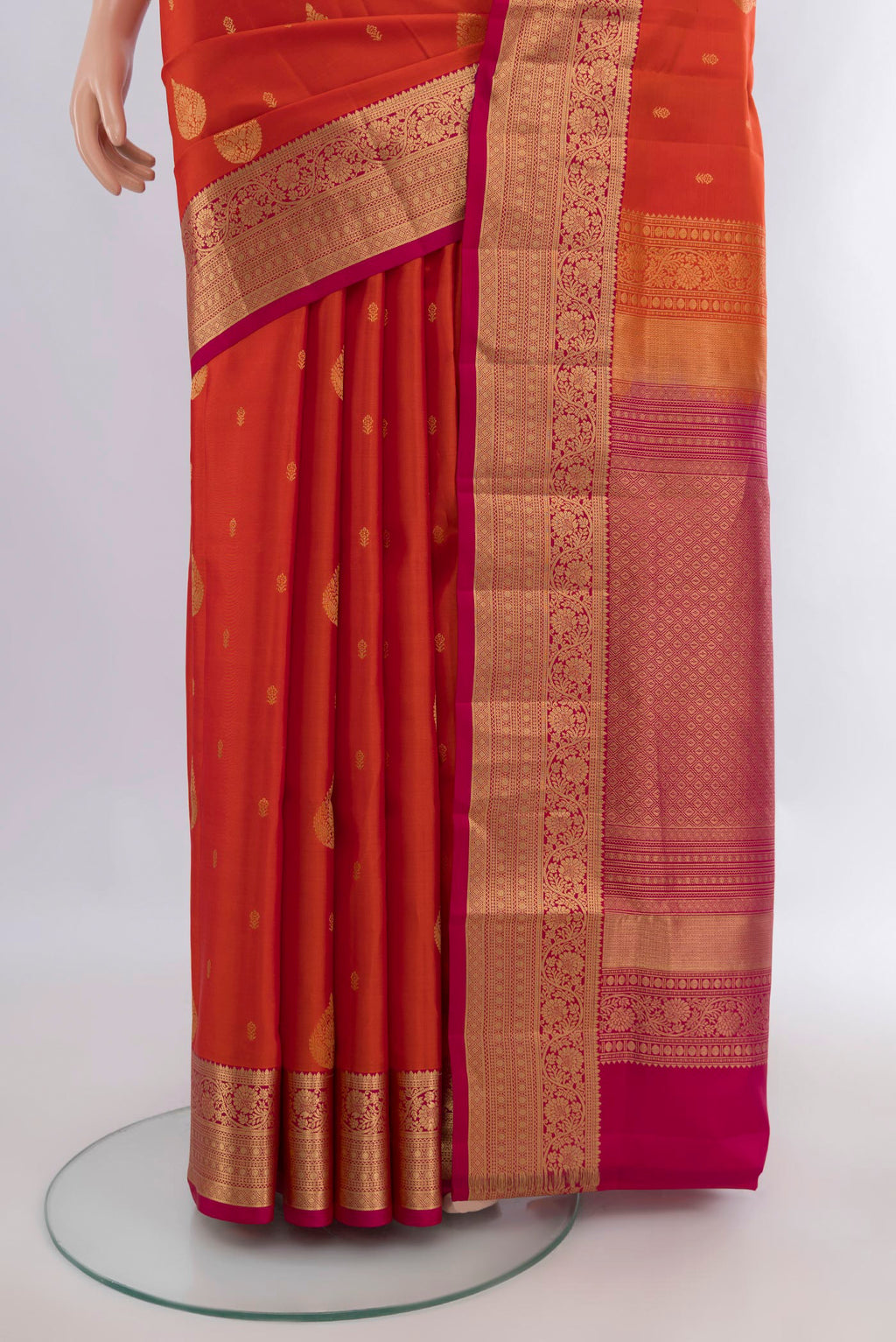 Pleats and pallu of Pure Silk Brick Orange Soft Saree with Zari Butta on the body and Zari Border. 