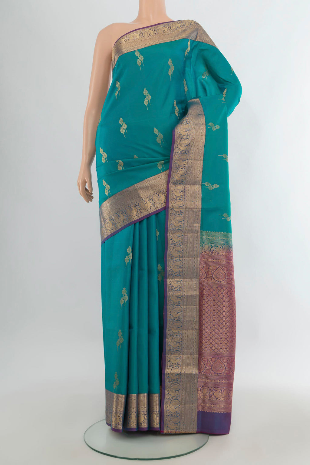 Pure Silk Peacock Blue Soft Saree with Zari Butta on the body and Zari Border.  displayed on a mannequin