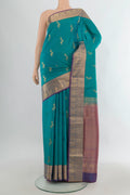 Pure Silk Peacock Blue Soft Saree with Zari Butta on the body and Zari Border.  displayed on a mannequin