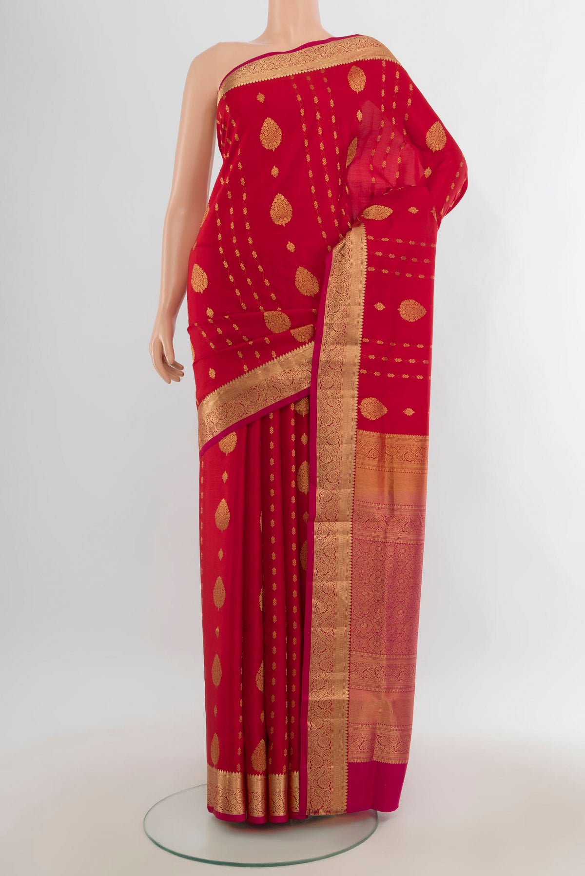 Pure Silk Red Soft Saree with Zari Butta on the body and Silk Border.  displayed on a mannequin