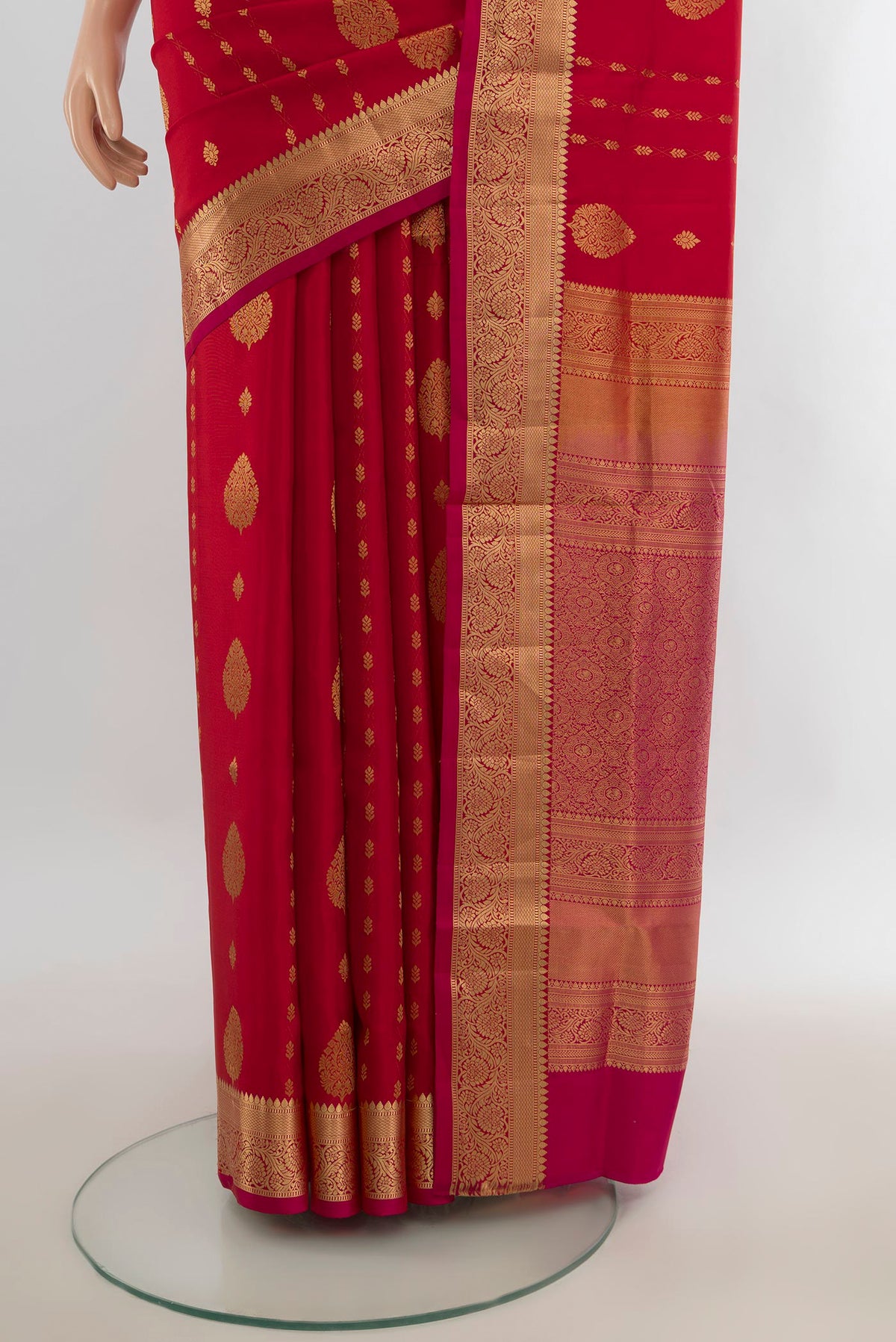 Pleats and pallu of Pure Silk Red Soft Saree with Zari Butta on the body and Silk Border. 
